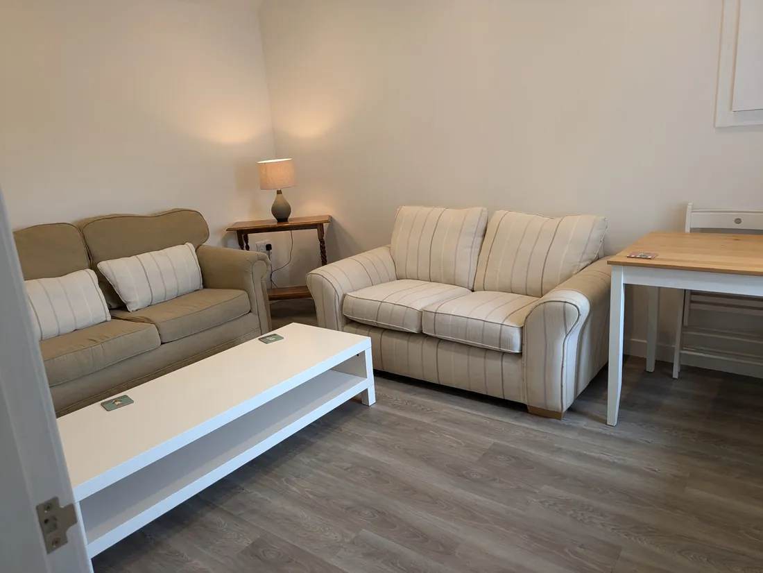Two sofas and a white coffee table in The Cottage living room
