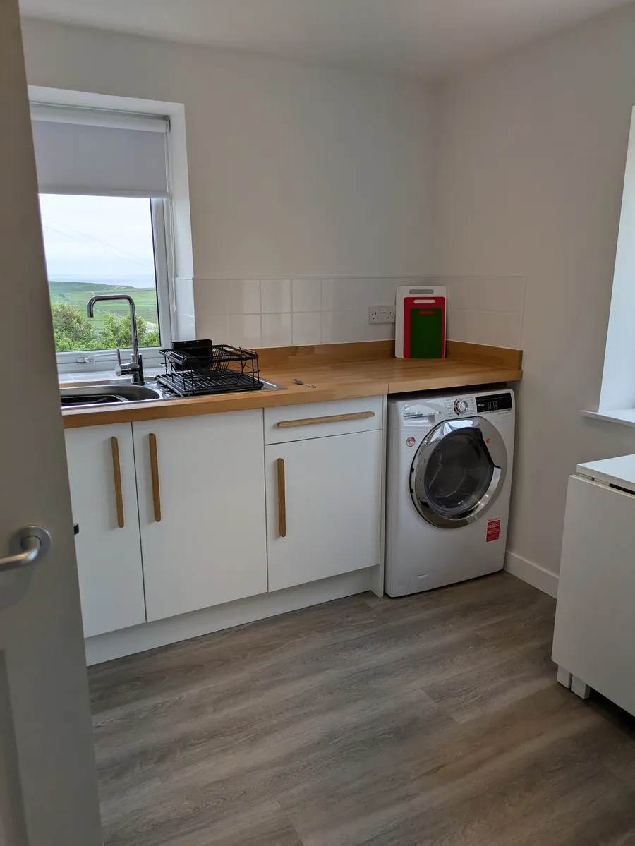 Washer-dryer beneath the cottage kitchen worktop